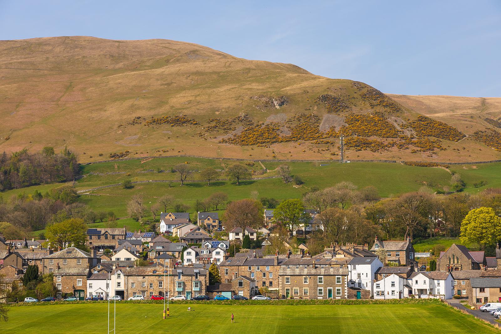 Sedbergh, Yorkshire, UK - 20 April 2019: View of the buildings of the Sedbergh village. Beautiful garden. Sunny spring day. Sedbergh, Yorkshire Dales, UK