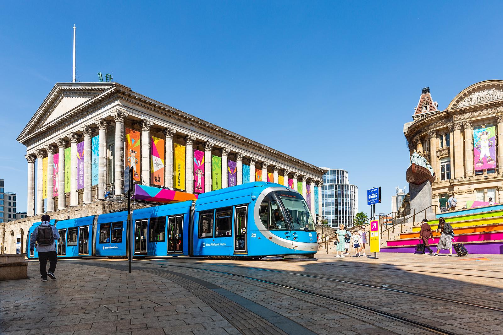 BIRMINGHAM, UK - JULY 28, 2022. A West Midlands Metro Tram travelling along tracks at Victoria Square in Birmingham city centre during The Commonwealth games