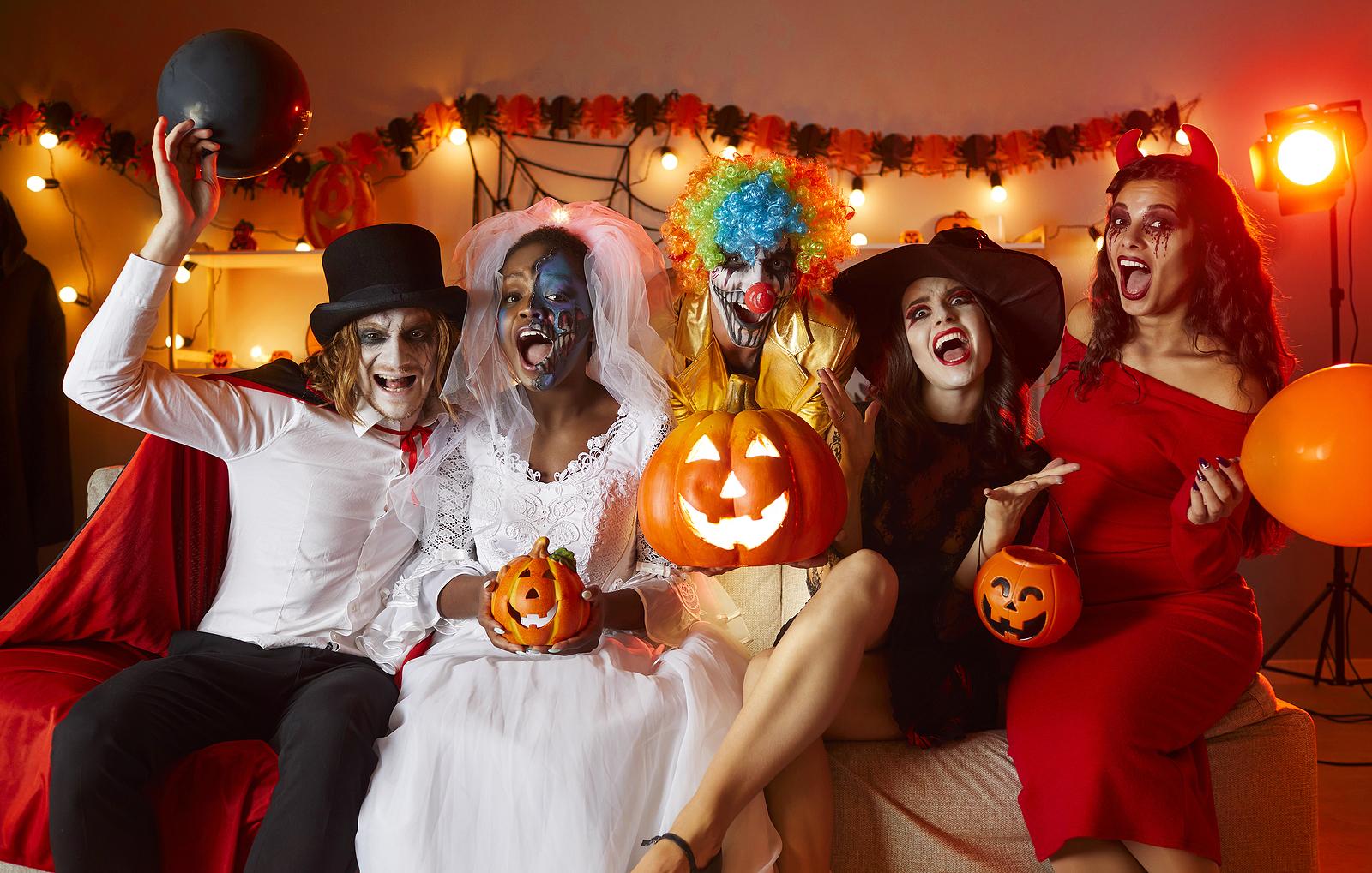 Group Of People In Halloween Costumes Sitting On Couch And Screa