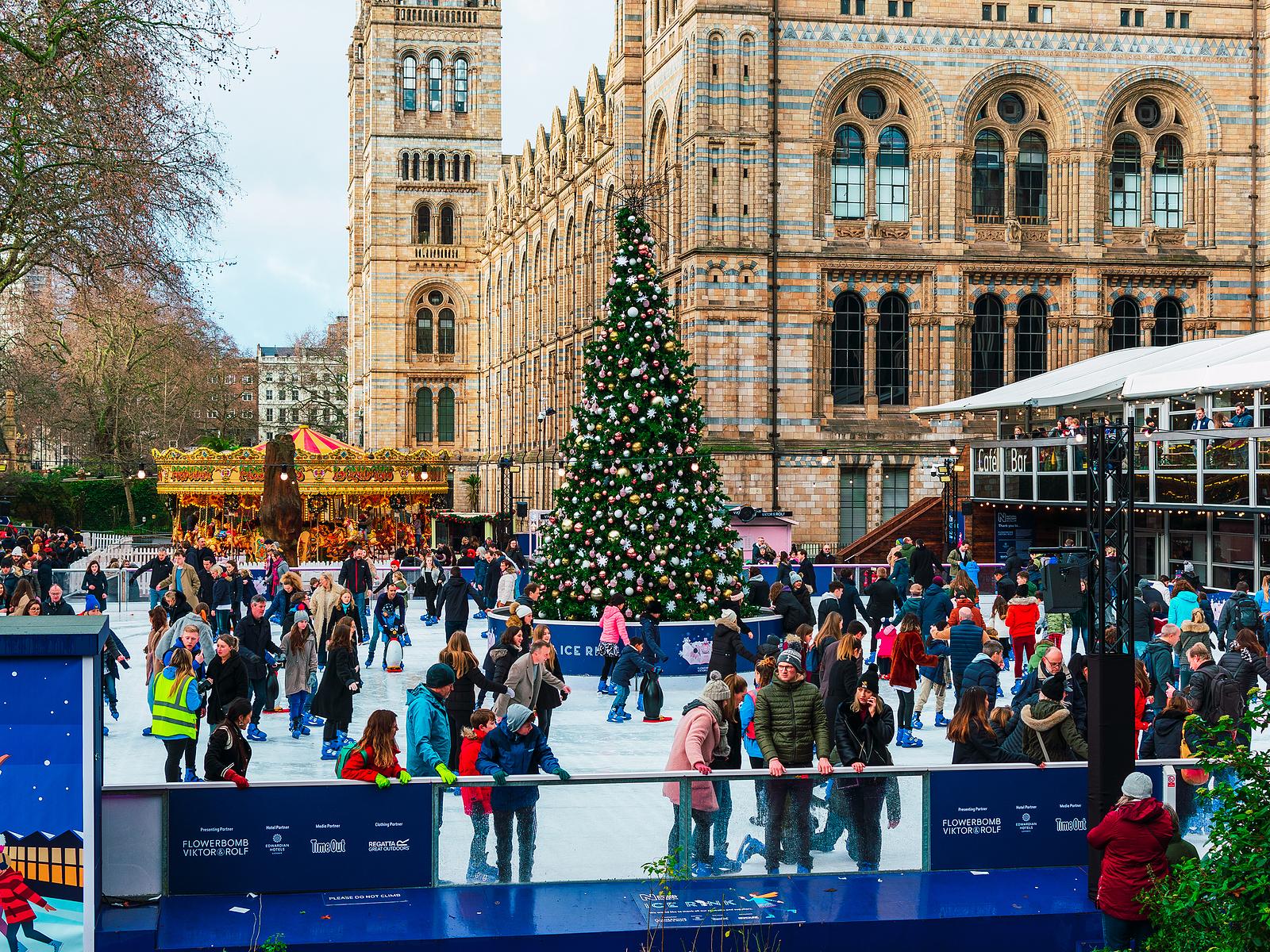 London, UK/Europe; 21/12/2019: Ice rink and Christmas tree at Natural History Museum in London. People enjoying ice skating at Christmas in front of one of the most famous museums of the city.